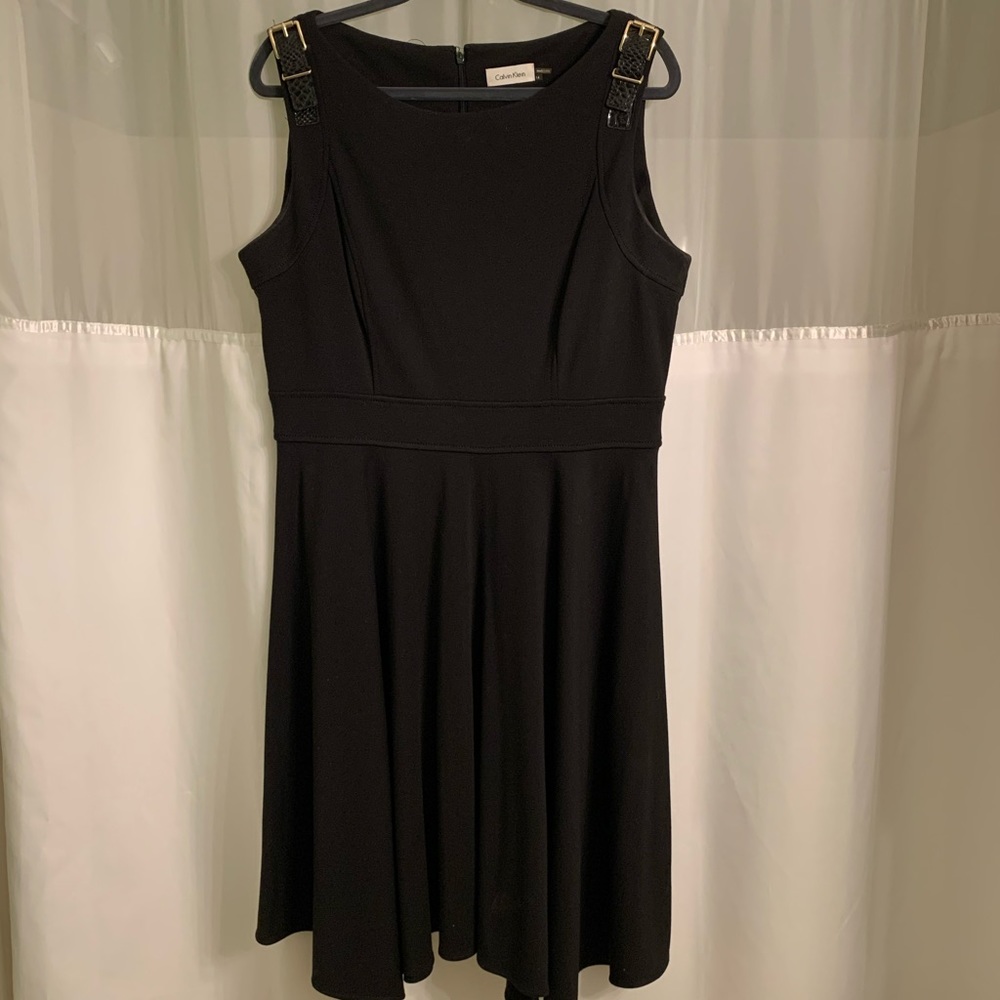 Black cocktail dress with gold buckle accents